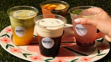 Selection of four iced coffees and refreshing drinks on a flower patterned plate