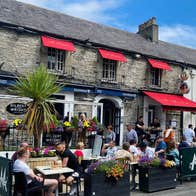 People sitting in a dining area outside a pub