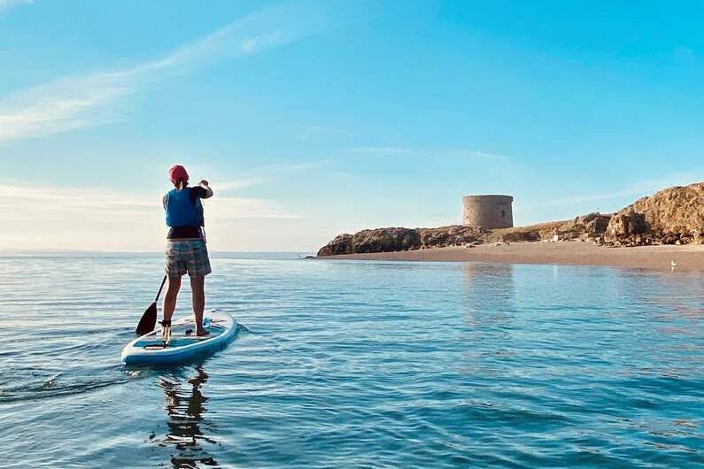 Image of a person on a stand up paddle board.