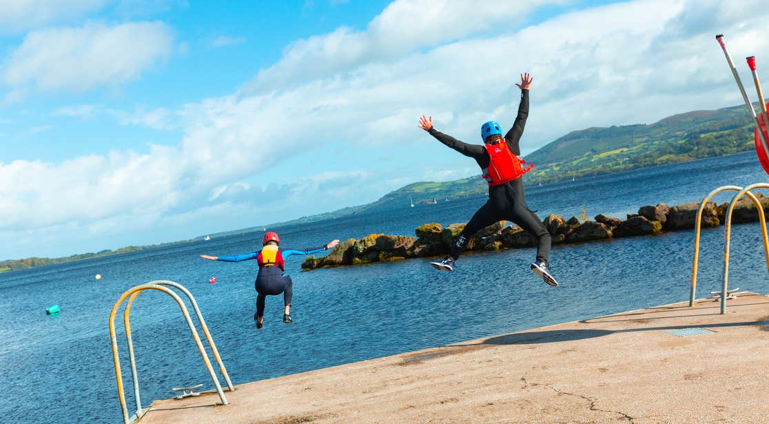 Two people jumping into the water at the UL Sports Adventure Centre in Killaloe in County Clare.