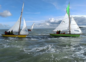 Three sail boats out on the ocean