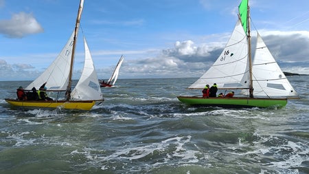 Three sail boats out on the ocean