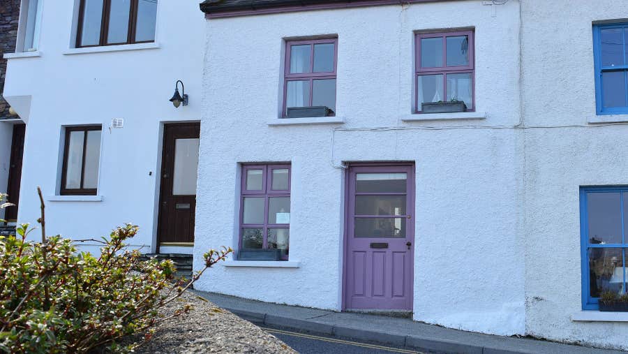 Front view of property with purple door