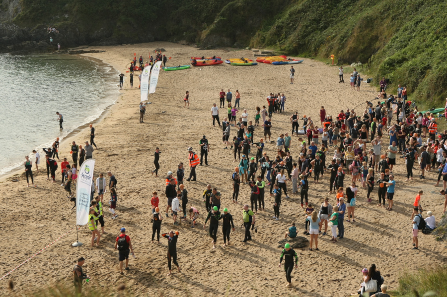 Athletes and marshals preparing for the start of the race on Baginbun Beach