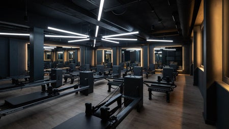 Spaced out exercise equipment and benches in a gym