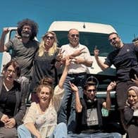 Film - Palestine Comedy Club, a group of 7 people at the front of a white van on a sunny day.