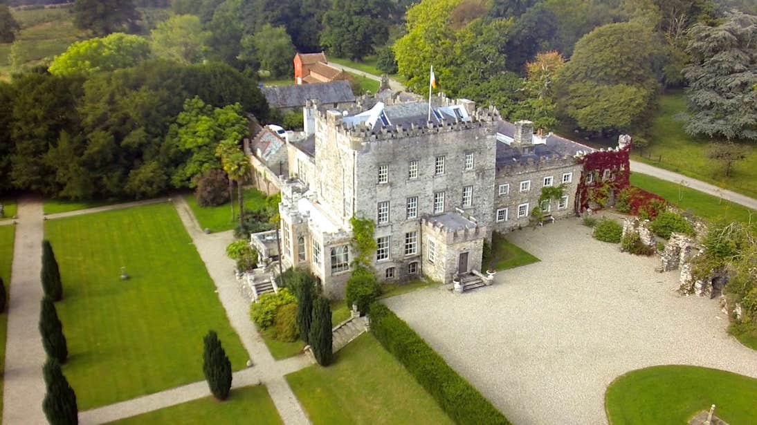 Aerial view of Huntington Castle in County Carlow surrounded by trees and lawns