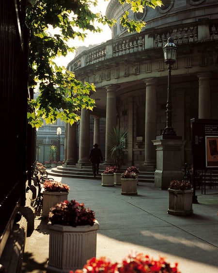 An exterior image of a person walking into the National Museum of Ireland - Archaeology building