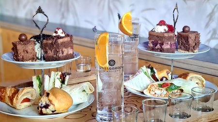Afternoon tea of cakes sandwiches served with a gin at the Stillgarden Distillery