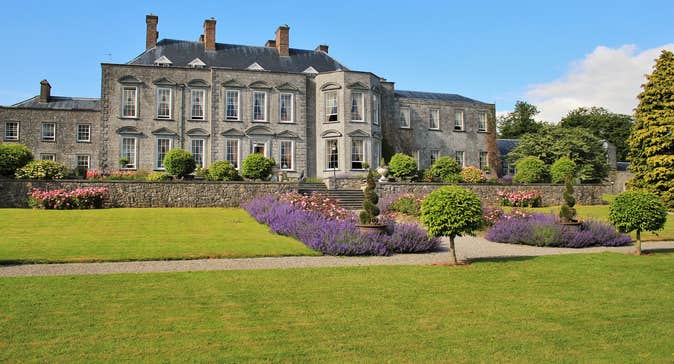 Immaculate lawns and flowerbeds outside Castle Durrow back garden in County Laois