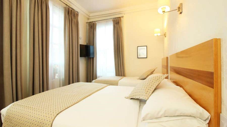 Double and single bed with white sheets