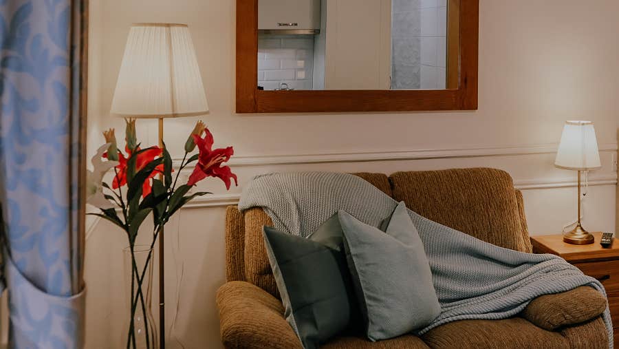 Orange couch with grey throws