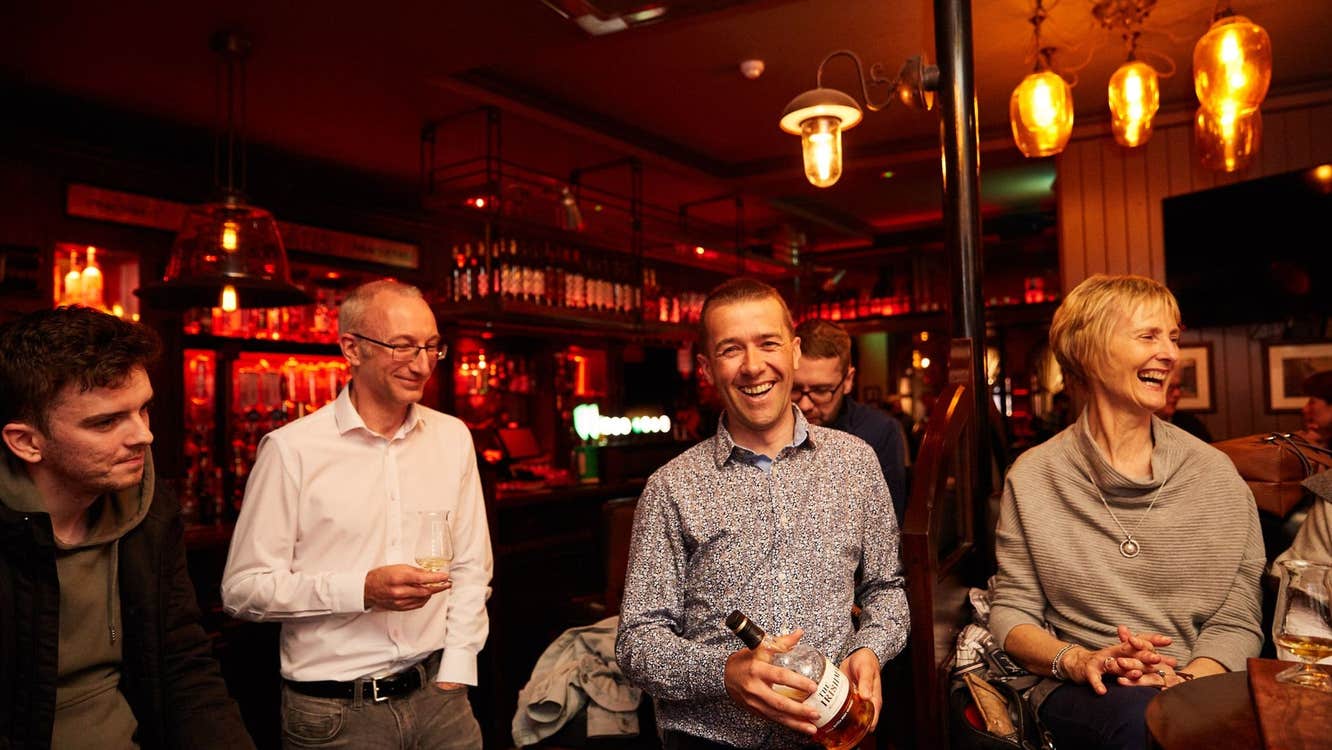 A group of four people enjoying a whiskey tasting