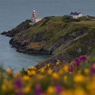 Image of a small house and the lighthouse at Howth Head, Dublin