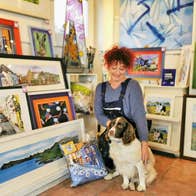 It Must Be Dingle Gallery interior of shop with paintings dog and owner