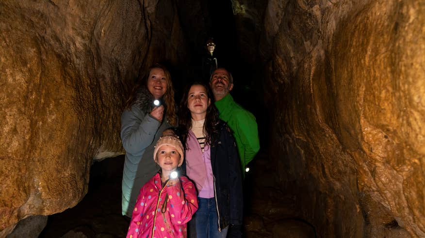 Family exploring a cave.