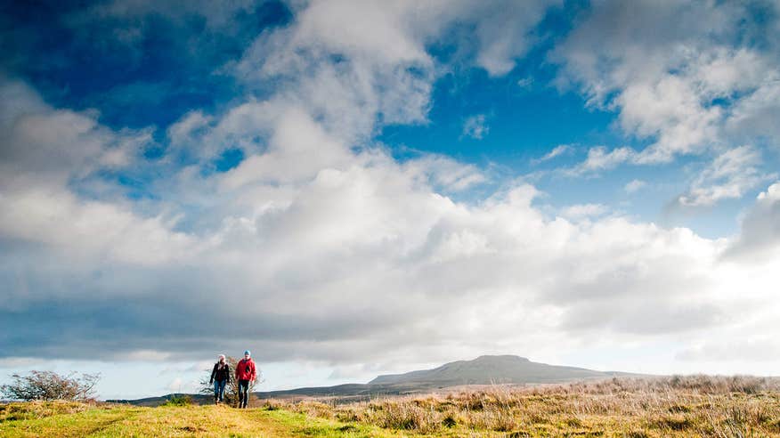 Blue skies over a couple walking in Cavan Burren Park, County Cavan