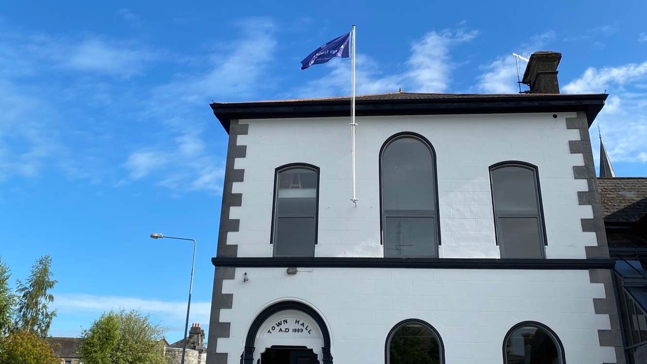 An image of the exterior of the black and white Town Hall where Nenagh Community Tourist Office is located inside