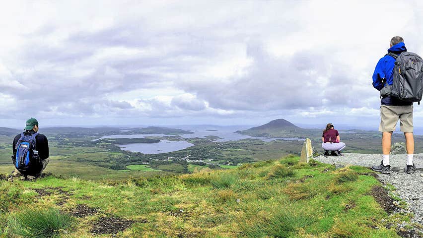 Beyond the Glass Eight Day Explorer Tour group on a hill overlooking scenic Connemara National Park