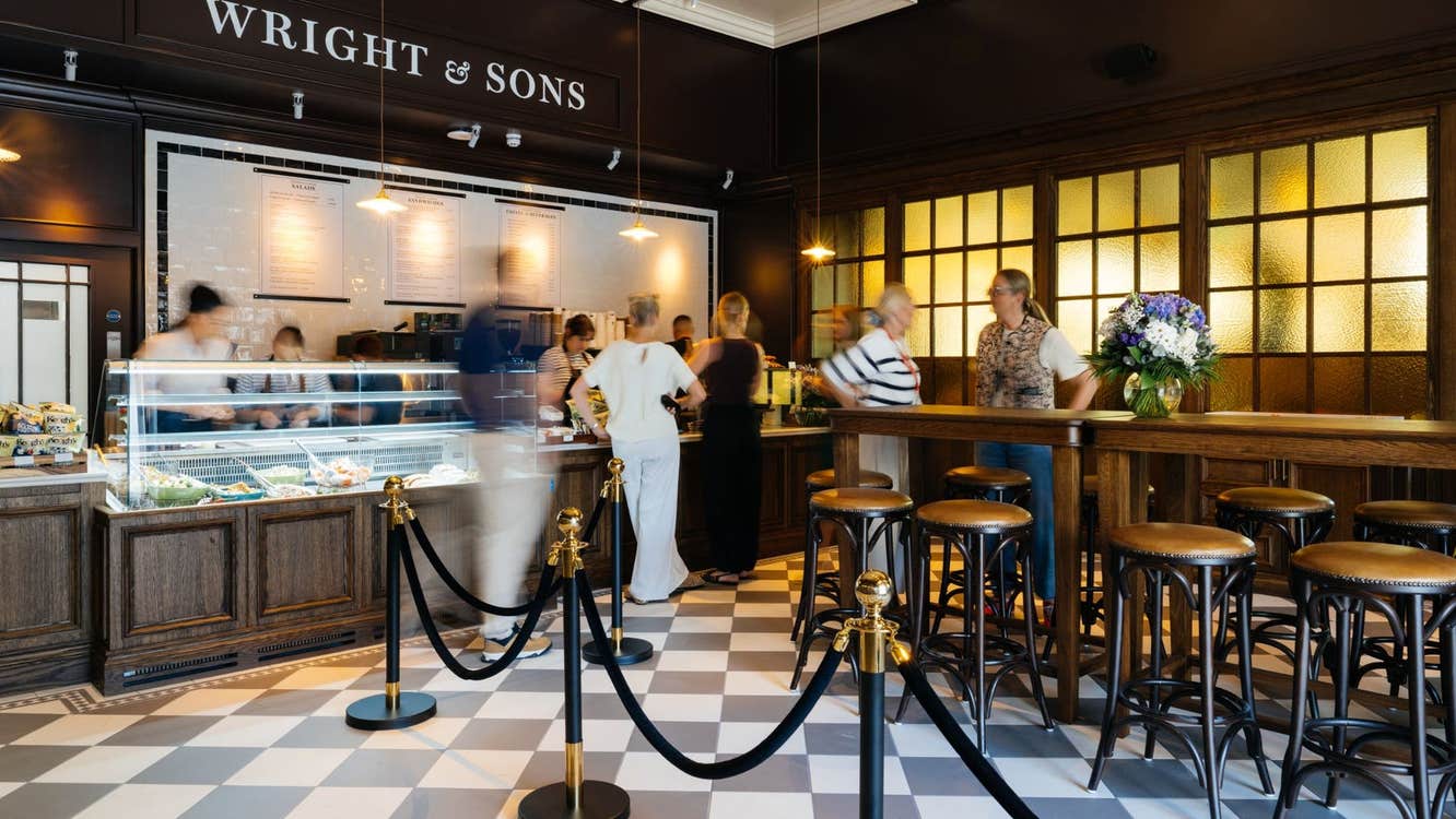 The interior of a bar with people queuing at the deli