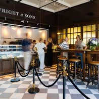 The interior of a bar with people queuing at the deli
