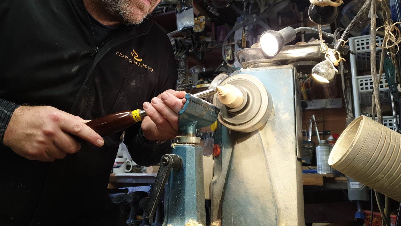 A woodturner at work with a piece of wood