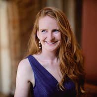 Aisling Kenny, soprano - a smiling woman with long hair in evening dress