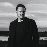 A black-and-white image of Niall Breslin. A bleak mood is suggested.