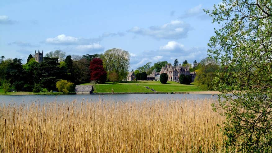 Green grass and blue water in front of Castle Leslie Estate, Monaghan