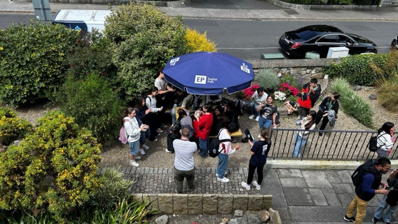 The grounds of a school with students walking around