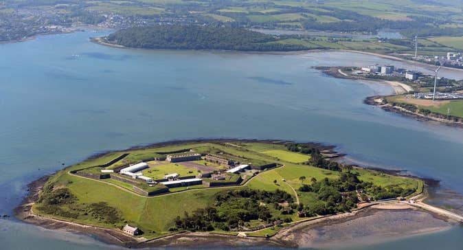 Island from the air with the sea around it and mainland in the background
