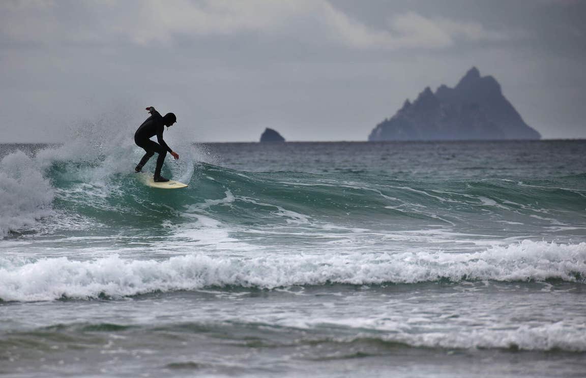 A surfer catching a wave in the Atlantic Ocean in Kerry.