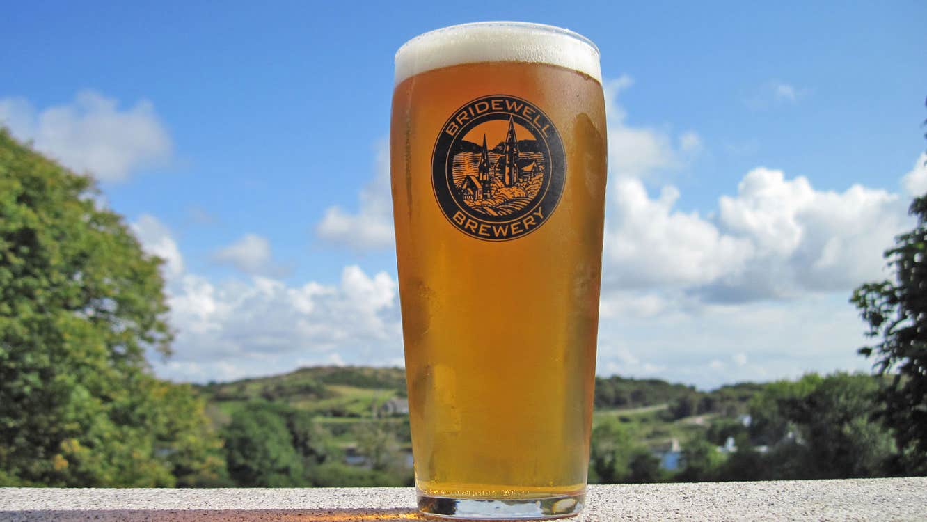Bridewell Brewery pint of blond ale in the sunshine in front of Connemara hills