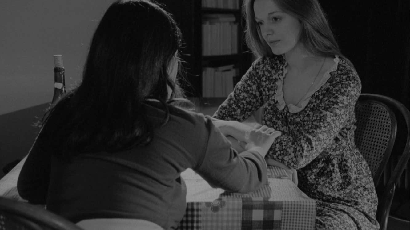 Two women are sitting at table.