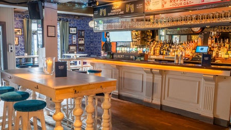 Wooden high table and bar in a pub