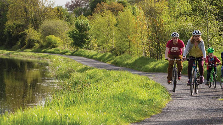 A family of five cycling along the Royal Canal Greenway path