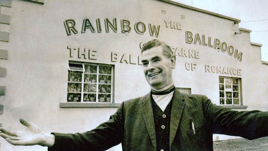 Rainbow Ballroom of Romance exterior and host in a black and white photo