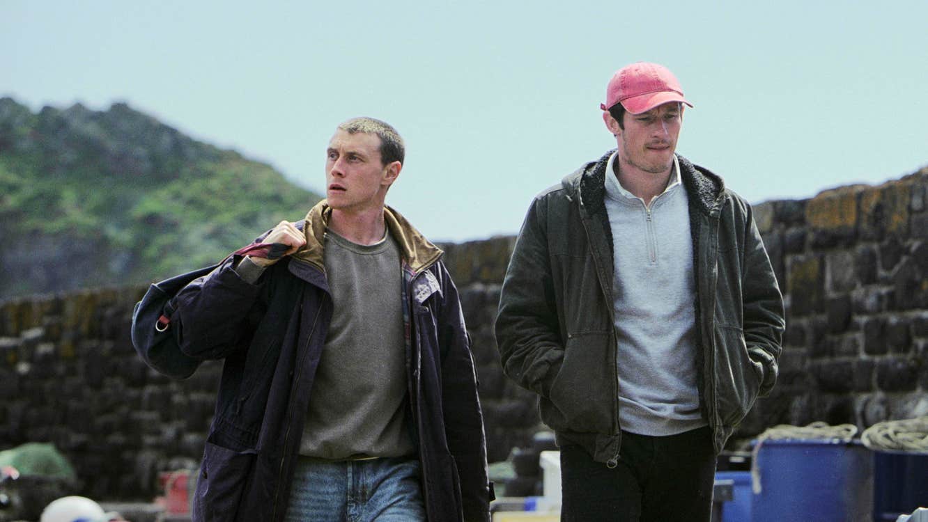 Two men walking along a dock.