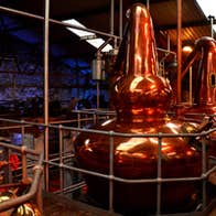 A copper still in a whiskey distillery