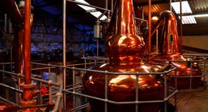 A copper still in a whiskey distillery