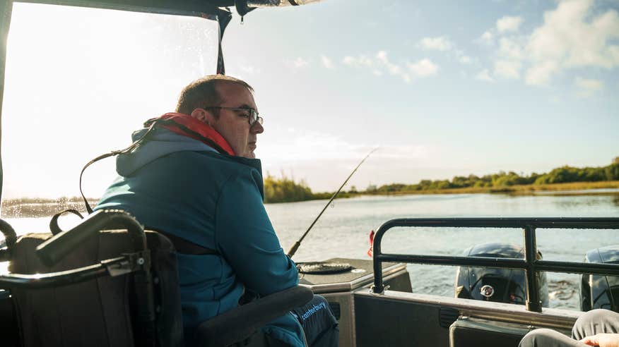 A man in a wheelchair fishing on a boat in Lough Ree in County Roscommon.