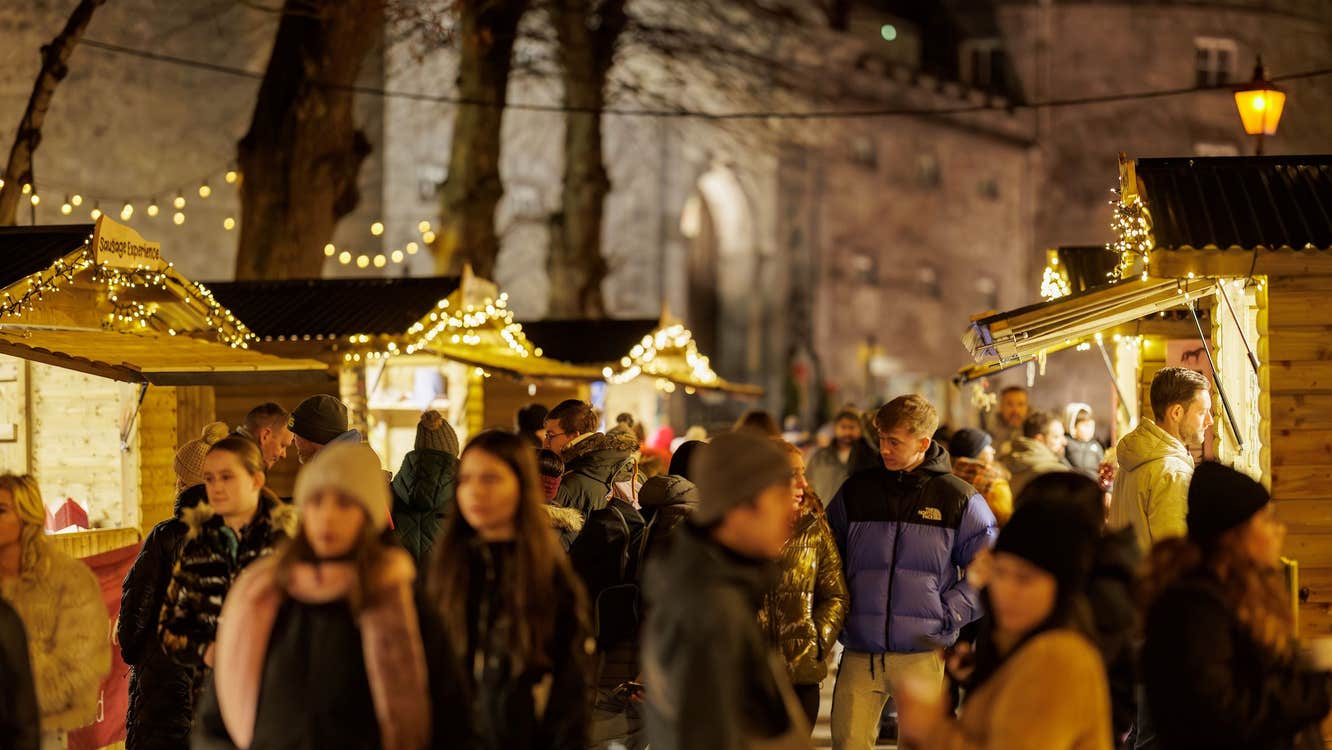Twinkling Christmas Chalets sell festive goods overlooked by Kilkenny Castle