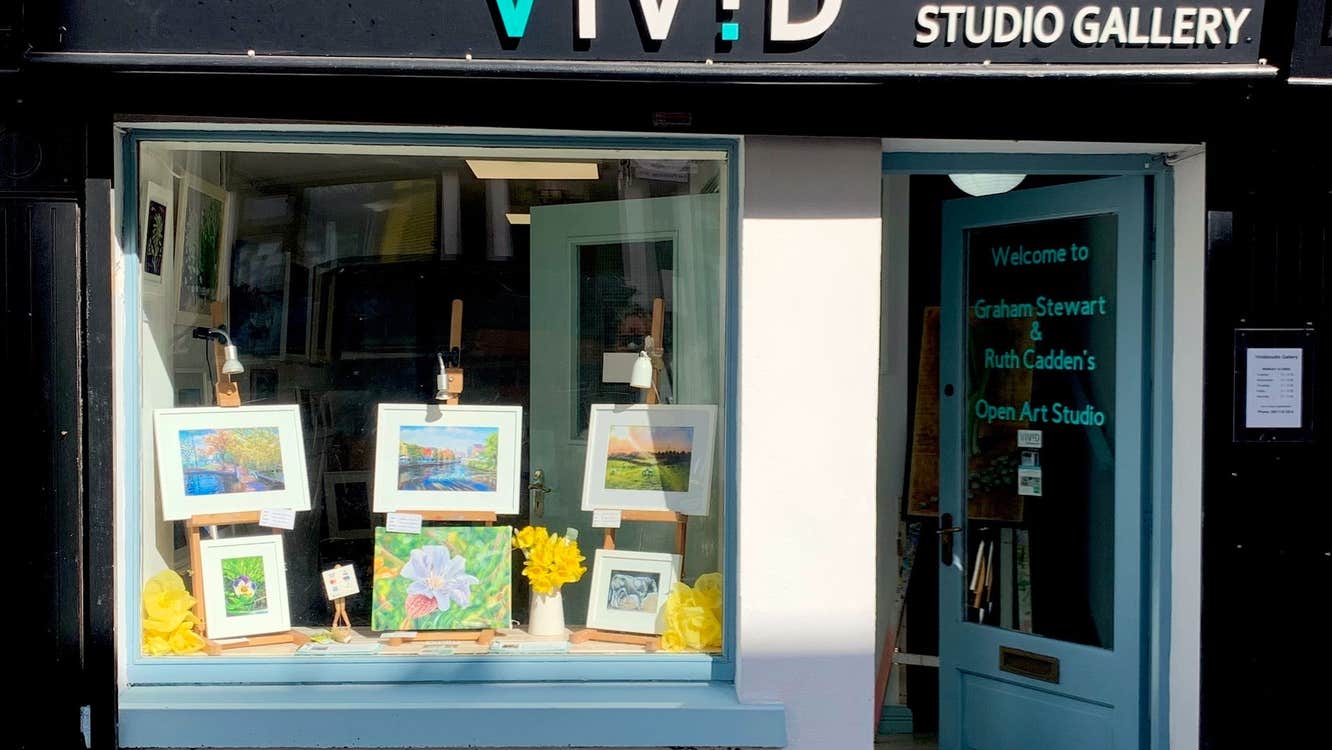 Shop front of Vivid Studio Gallery with paintings on display in window
