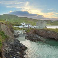 Cliffs and sea with a castle and beach behind