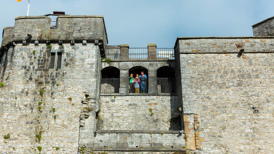 A family standing on the balcony of King John's Castle in Limerick.