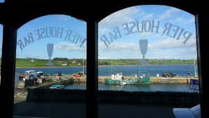 Photo looking out at the pier through the bar window.