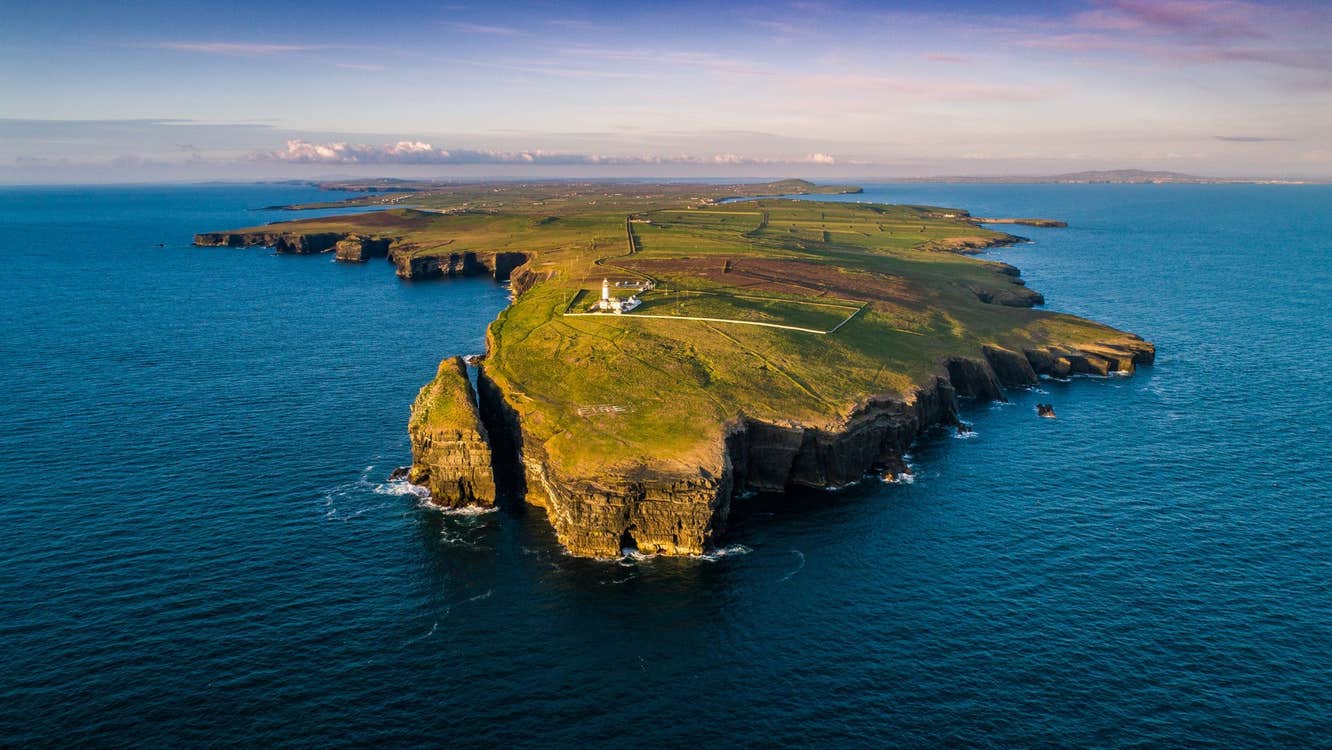 An aerial view of Loop Head and the lighthouse from the ocean