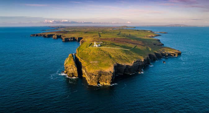 An aerial view of Loop Head and the lighthouse from the ocean