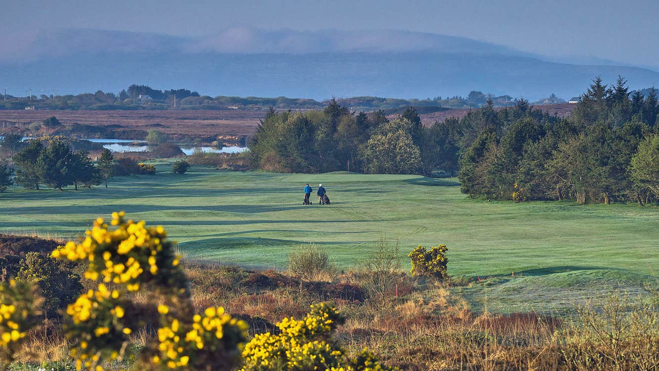 Bearna Golf Club players on a green with a view of mountains in the background