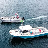 Two Kerry Aqua Terra boats sail beside each other at sea
